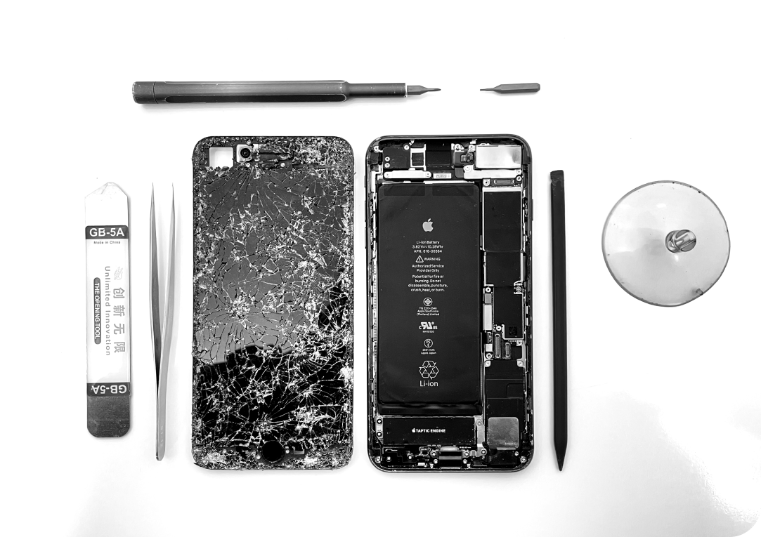 A disassembled apple phone and screen repair lies on a white surface.