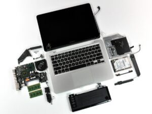 A disassembled laptop windows repair lies on a white surface.